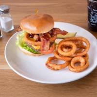 Wild West Burger · Applewood-smoked bacon, onion rings, BBQ sauce, cheddar cheese, lettuce, tomato and mayo.