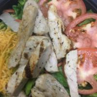 Grilled Chicken Salad · Grilled chicken over a bed of romaine heart lettuce, tomatoes, carrots and shredded cheddar ...