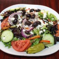 Greek Salad · Lettuce topped with tomatoes, onions, cucumbers, red peppers and feta cheese. Served with ou...