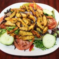 Chicken Shawarma Salad · Greek salad topped with grilled marinated chicken breast and sauteed with hot sauce and lemo...