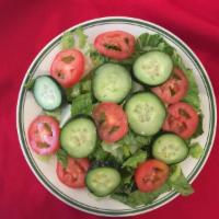 House Salad · Tomatoes, cucumbers, and lettuce in a special sauce.