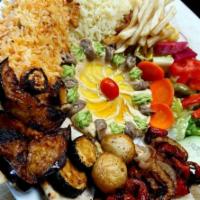 Veggie Tawook · Mushroom, tomato, broccoli, onion, zucchini, served with rice and hummus salad plus fries. V...