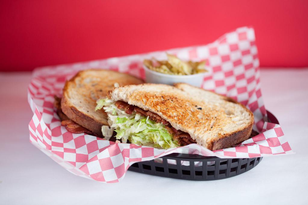 Bacon Lettuce and Tomato · Applewood slow smoked thick cut bacon slices, crunchy iceberg lettuce, fresh sliced tomato, and house made mayonnaise on a Pearl Bakery Levain sourdough grilled to perfection.