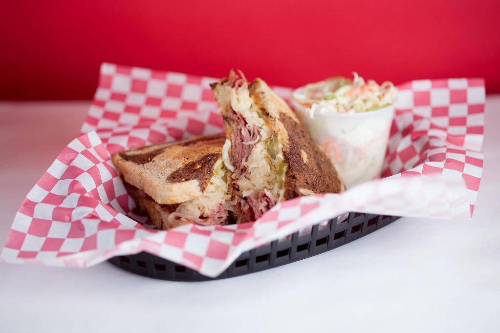 The Charlie's Reuben · Charlie's home made traditional corned beef, smoked Swiss cheese, sauerkraut, 1000 island sauce, and waffle cut pickles on a fresh buttered Pearl Bakery marble rye bread.