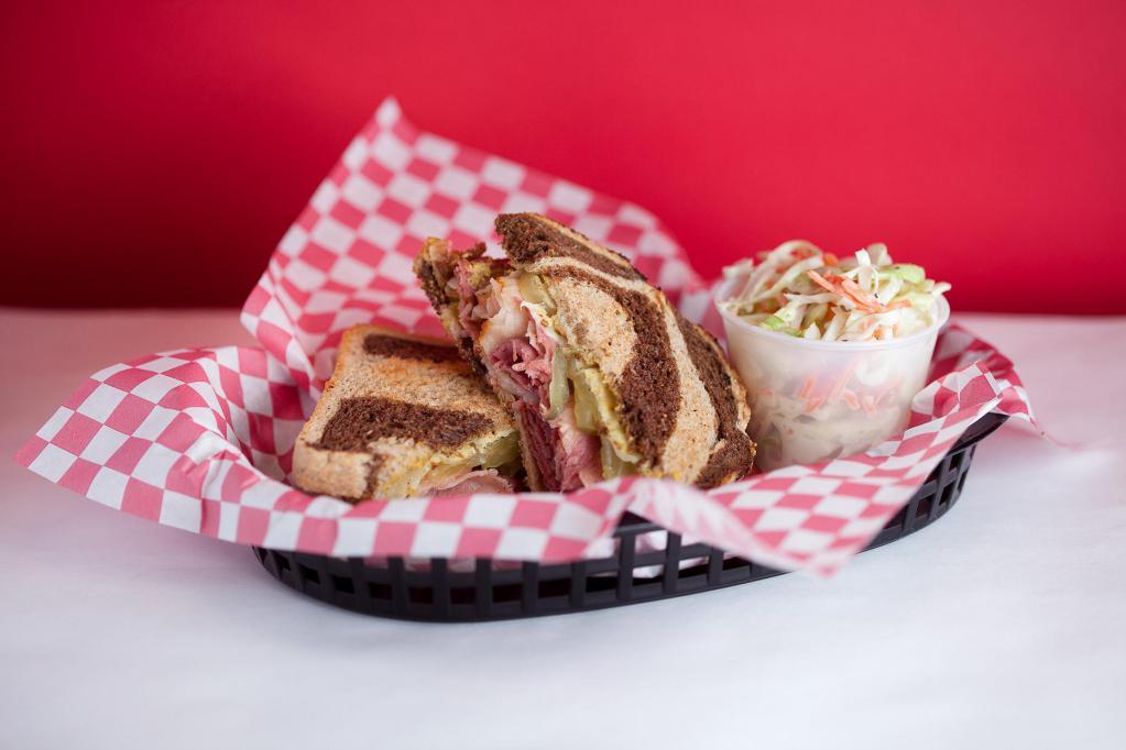 Charlie's Corned Beef on Rye · Charlie's home made traditional corned beef, smoked Swiss cheese, French's yellow mustard, and pickles on a Pearl Bakery marble rye bread.