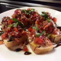 Bruschetta · Toasted Italian bread topped with diced tomatoes, onion, and fresh basil and garlic drizzled...