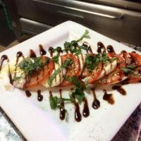 Caprese Salad · Thick-sliced tomatoes topped with fresh mozzarella cheese and basil drizzled with extra virg...