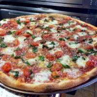 Margherita Pizza · Topped with tomatoes, fresh mozzarella and fresh basil drizzled with extra virgin olive oil. 