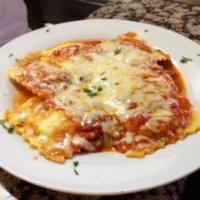 Cheese Ravioli · Cheese ravioli with marinara sauce and mozzarella cheese baked in our stone oven.