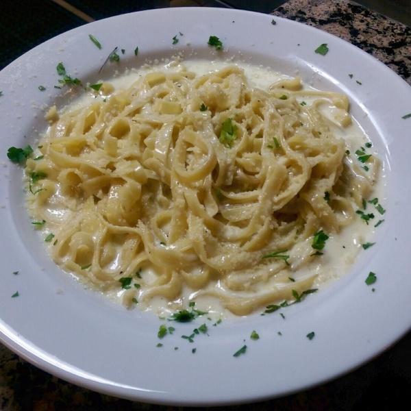 Fettuccine Alfredo · Our house-made Alfredo sauce tossed with fettuccine pasta.