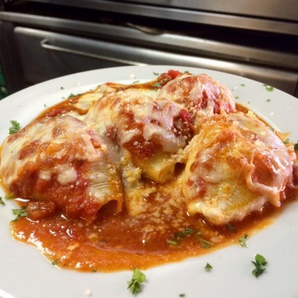 Stuffed Shells · Shells stuffed with our homemade seasoned ricotta and topped with marinara and mozzarella cheese, baked to perfection.