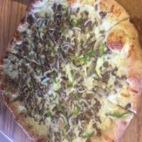 Philly Cheese Steak Pizza · Shaved steak, red onions, green peppers, mushrooms, provolone, and mozzarella cheese.