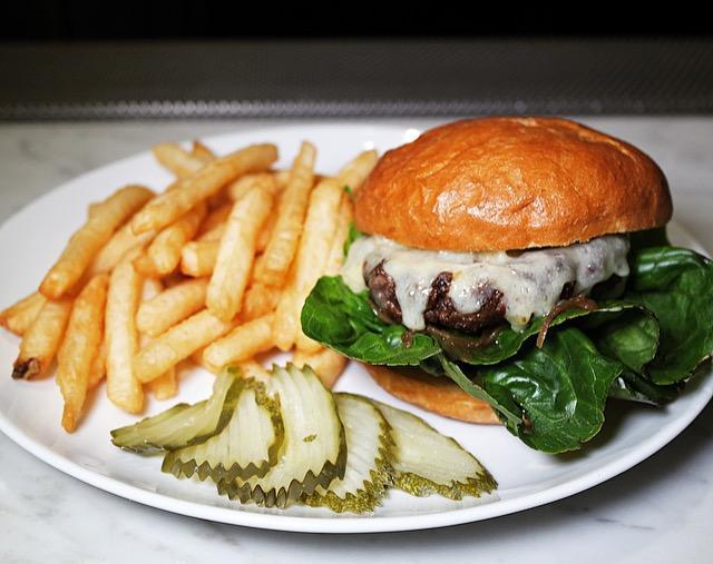 The Bartlett Burger · Niman Ranch beef, caramelized onion, chive aioli, gem lettuce, house pickles, served with choice of Extra Sharp Cheddar, Gorgonzola or Brie and an acme bun. Served w/ Fries