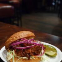 Pulled Pork Sandwich · Slow roasted pulled pork, house bbq sauce, jalapeño cabbage slaw, red onion, served w/ pickl...