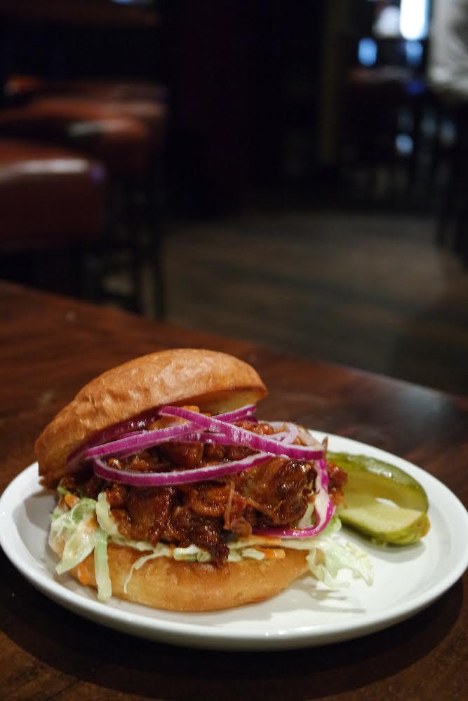 Pulled Pork Sandwich · Slow roasted pulled pork, house bbq sauce, jalapeño cabbage slaw, red onion, served w/ pickles on the side and house potato chips