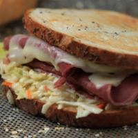 Reuben Lunch · Homemade corned beef or turkey, grilled onions, Swiss, coleslaw and Thousand Island dressing...