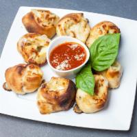 John's Garlic Rolls · Fresh garlic, olive oil and mozzarella cheese wrapped in our homemade dough. Served with mar...