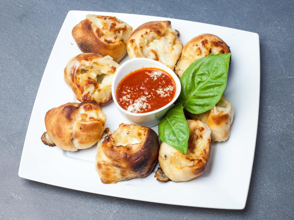 John's Garlic Rolls · Fresh garlic, olive oil and mozzarella cheese wrapped in our homemade dough. Served with marinara sauce.