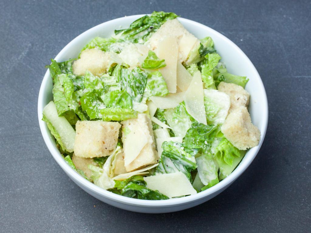 Caesar Salad · Fresh crisp romaine lettuce, shaved Parmesan cheese and croutons tossed in our Caesar dressing.