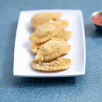 Toasted Ravioli · A delicious blend of cheese-filled ravioli, fried until crisp and served with Fiorella's sig...