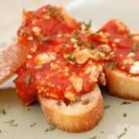 Baked Feta Marinara · Feta cheese baked with our homemade marinara sauce, served with toasted wedges of our homema...