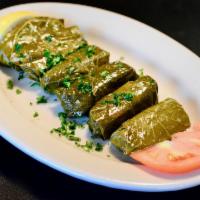 Grape Leaves · Rolled grape leaves stuffed with rice, tomatoes, onions, parsley and mint. Slow cooked and s...