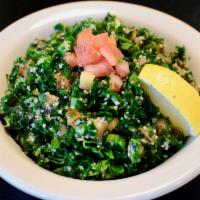 Tabouli Salad · Our traditional Lebanese salad made with diced parsley, burghal, tomatoes, mint, green onion...