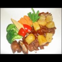 Tamarind Duck · Crispy roasted duck topped with pineapple and tamarind sauce.