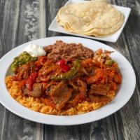 Bistec Ranchero · Steak, ranchero sauce, bell peppers, onions, comes with rice, beans and salad.