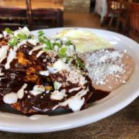 Chilaquiles en Mole Poblano · Crispy tortillas bathed in Homemade Mole Poblano. Served with Peruano Beans, 2 Eggs any styl...