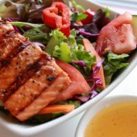 Grilled Wild Salmon Salad · Mixed green salad topped with grilled salmon. Served with a dinner roll, wedge of lemon and ...
