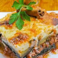 Moussaka · Layers of ground beef, eggplant, and bechamel sauce, topped with marinara sauce served, serv...