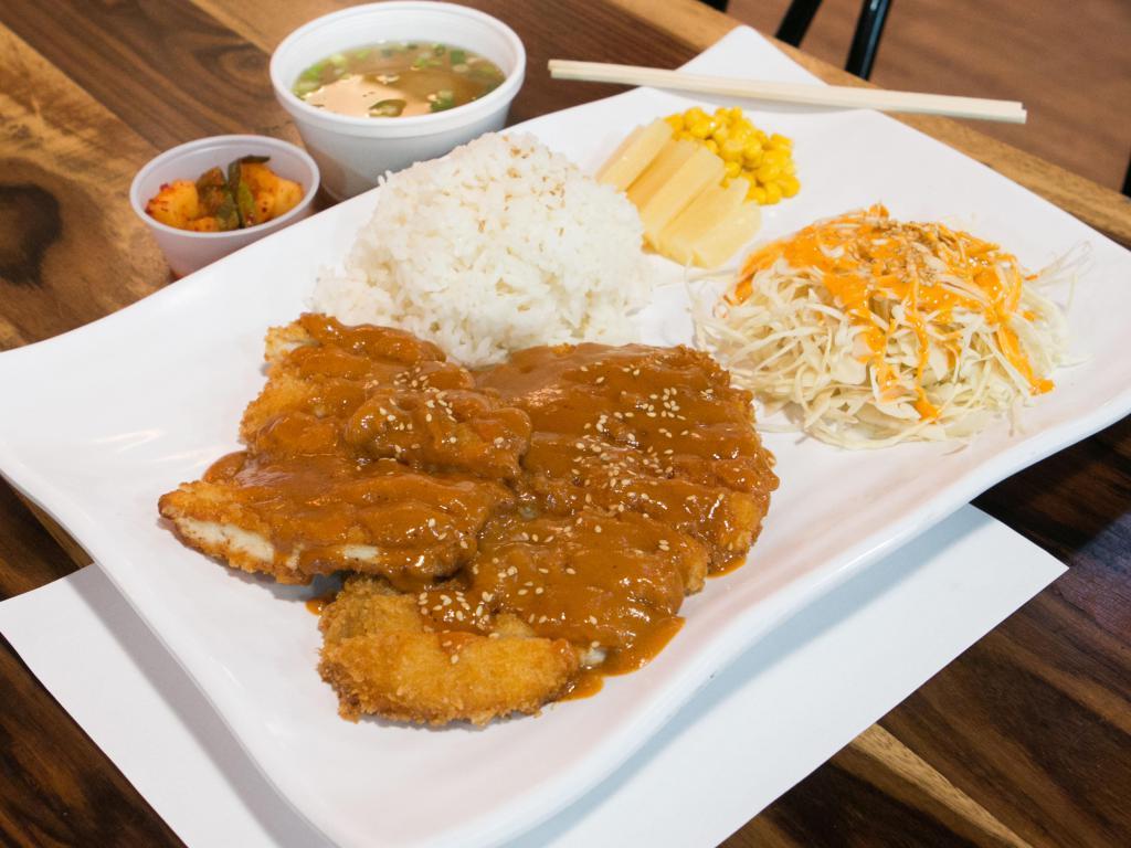 Don Katsu · Breaded, deep-fried pork cutlets covered in sauce. Served with white rice, salad and miso soup.