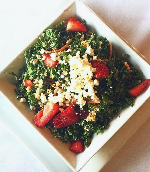 Kale and Quinoa Salad · Kale and greens mix, quinoa, toasted sunflower seeds, fresh strawberries, grapes, goat cheese and golden raisins. Tossed with raspberry vinaigrette. Gluten-free and vegetarian.