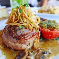 8 oz Bacon-Wrapped Filet Mignon with Peppercorn Sauce · 8 oz. prime grade Angus filet mignon topped with tiny onion rings and served with potatoes D...