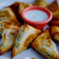 Spinach and Feta Triangles · Filo dough triangles stuffed with sauteed spinach and feta cheese, baked to a golden crisp a...