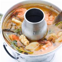 Seafood Tom Yum Soup · Shrimps, scallop, sole fish, squid, mushrooms and tomatoes. Served with rice. Spicy.