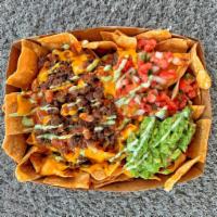 Mega Carne Asada Nachos · Corn tortillas, carne asada, beans, nacho cheese, guacamole, avocado cream, pico de gallo an...