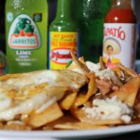 Chilaquiles · Fried corn tortillas-chips, served with beans, green sauce, onions, queso fresco, sour cream...