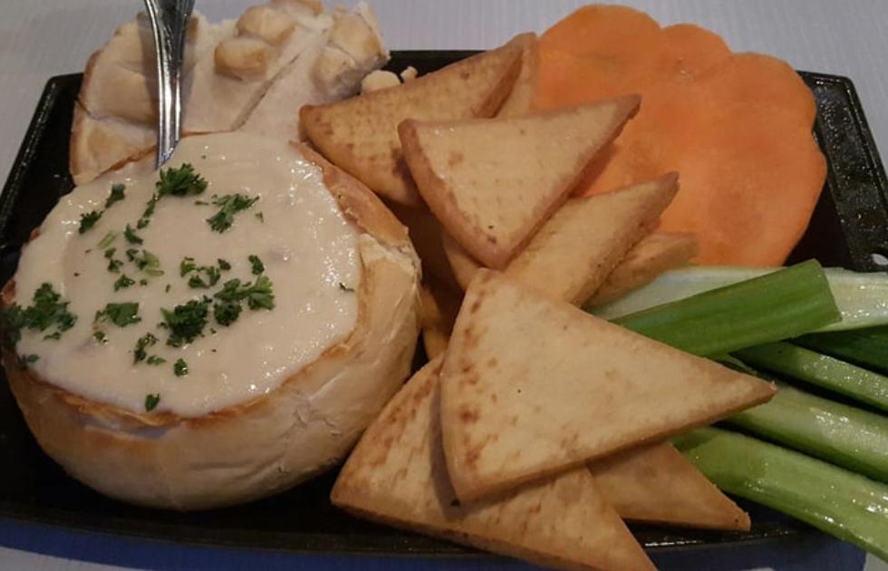 Slaters Vampire Dip · Roasted garlic and artichoke hearts blended with creamy melted cheese served in a sourdough bread bowl with crispy pita and veggies for dipping.