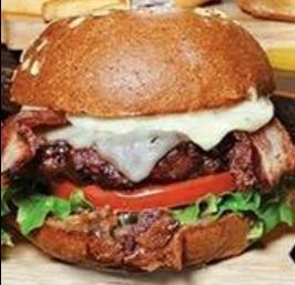 Bison and Bacon Burger · American ranch bison, thick-cut bacon, Swiss, Jalapeno bacon jam, tomato, green leaf lettuce, sage and garlic aioli and honey wheat bun.