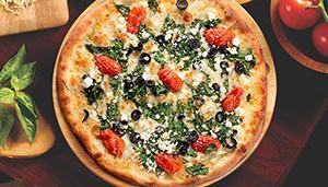 Mediterranean Pizza · Fresh spinach, Roma tomatoes, feta cheese, Wisconsin mozzarella, black olives and Sicilian e...