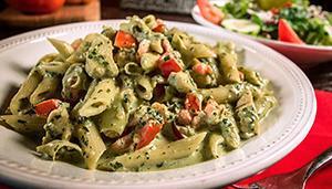 Chicken Pesto Pasta · Al dente penne pasta with grilled chicken, Roma tomatoes and artichoke hearts, tossed in a f...