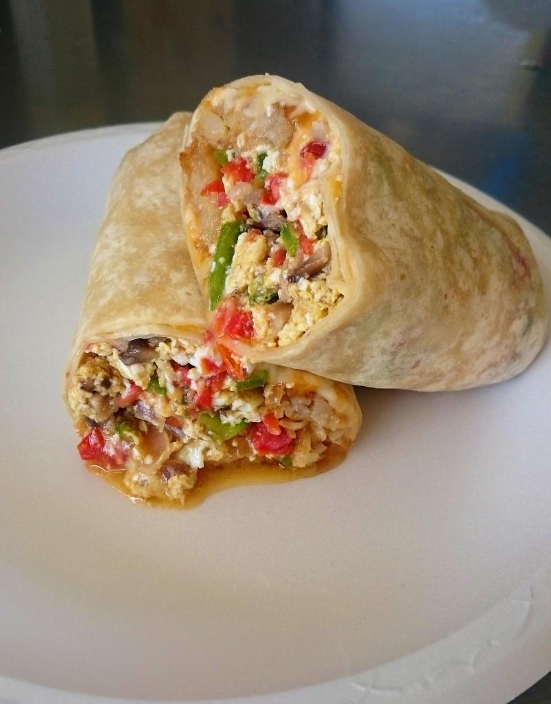 Veggie And Egg Burrito · 3 Eggs, hash brown, mushrooms, tomato, bell pepper, onion,  jack and cheddar cheeses.
