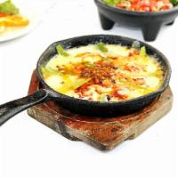Queso Fundido · Hot melted cheese topped with chorizo served with corn or flour tortillas.