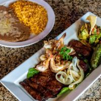 Mar y Tierra · A 10 oz. skirt steak chargrilled to perfection topped with 4 jumbo shrimp, grilled onions, g...