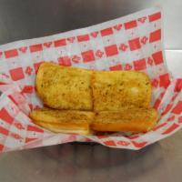 Garlic Bread · Four pieces of bread with our special garlic seasoning.