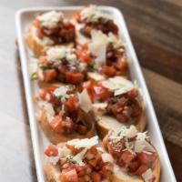 Bruschetta · Fresh diced tomatoes with garlic, basil, olive oil and balsamic vinegar. Served on eight pie...
