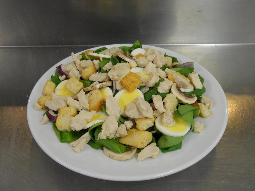 Fresh Spinach Salad with Chicken · Fresh spinach leaves with slices of hard boiled egg, sliced red onion, fresh sliced mushrooms and croutons.