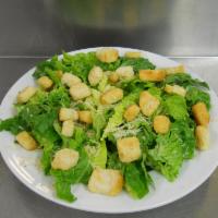 Caesar Salad · Crispy romaine lettuce, shaved Parmesan cheese and herbed croutons.